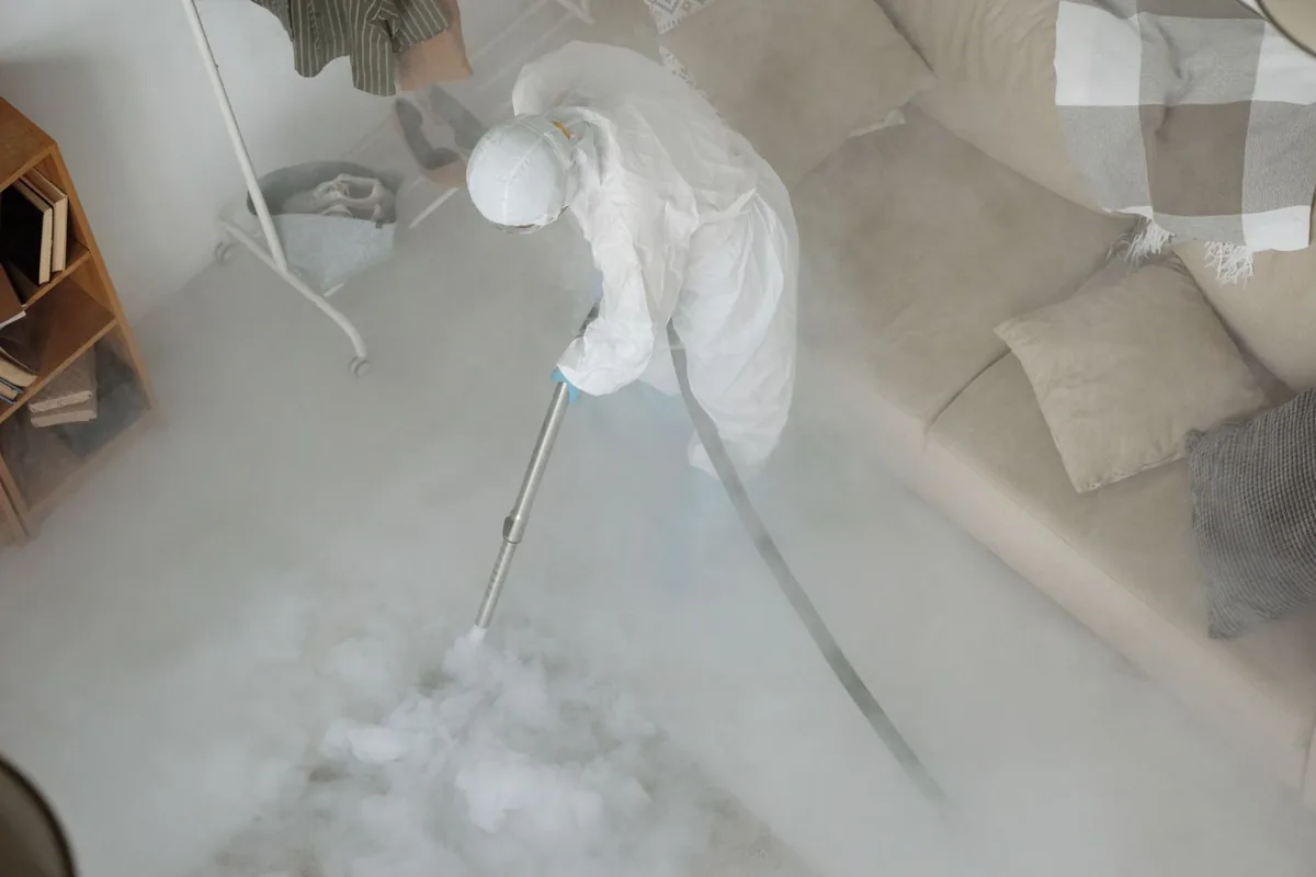 Biohazard cleanup technician in protective equipment, Rossville, GA